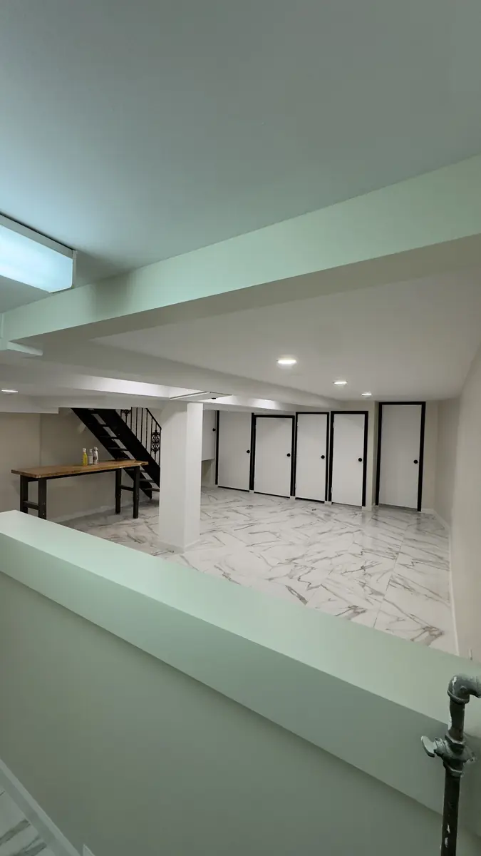 Basement renovation Yonkers NY — after photo by AlbStar Renovation showing bright finished basement marble tile