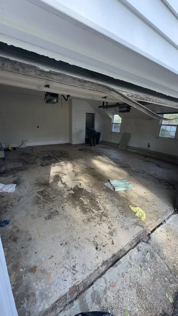 Epoxy flooring Westchester NY — before photo showing cracked dirty garage floor by AlbStar Renovation