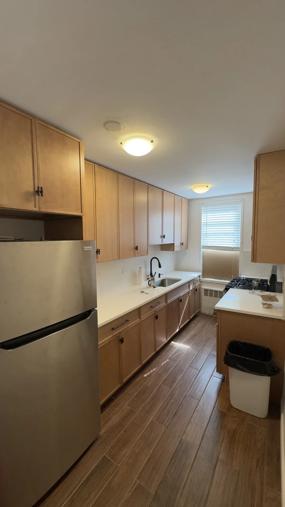 Kitchen remodeling Bronx NY — galley kitchen with maple cabinets and quartz countertops by AlbStar Renovation