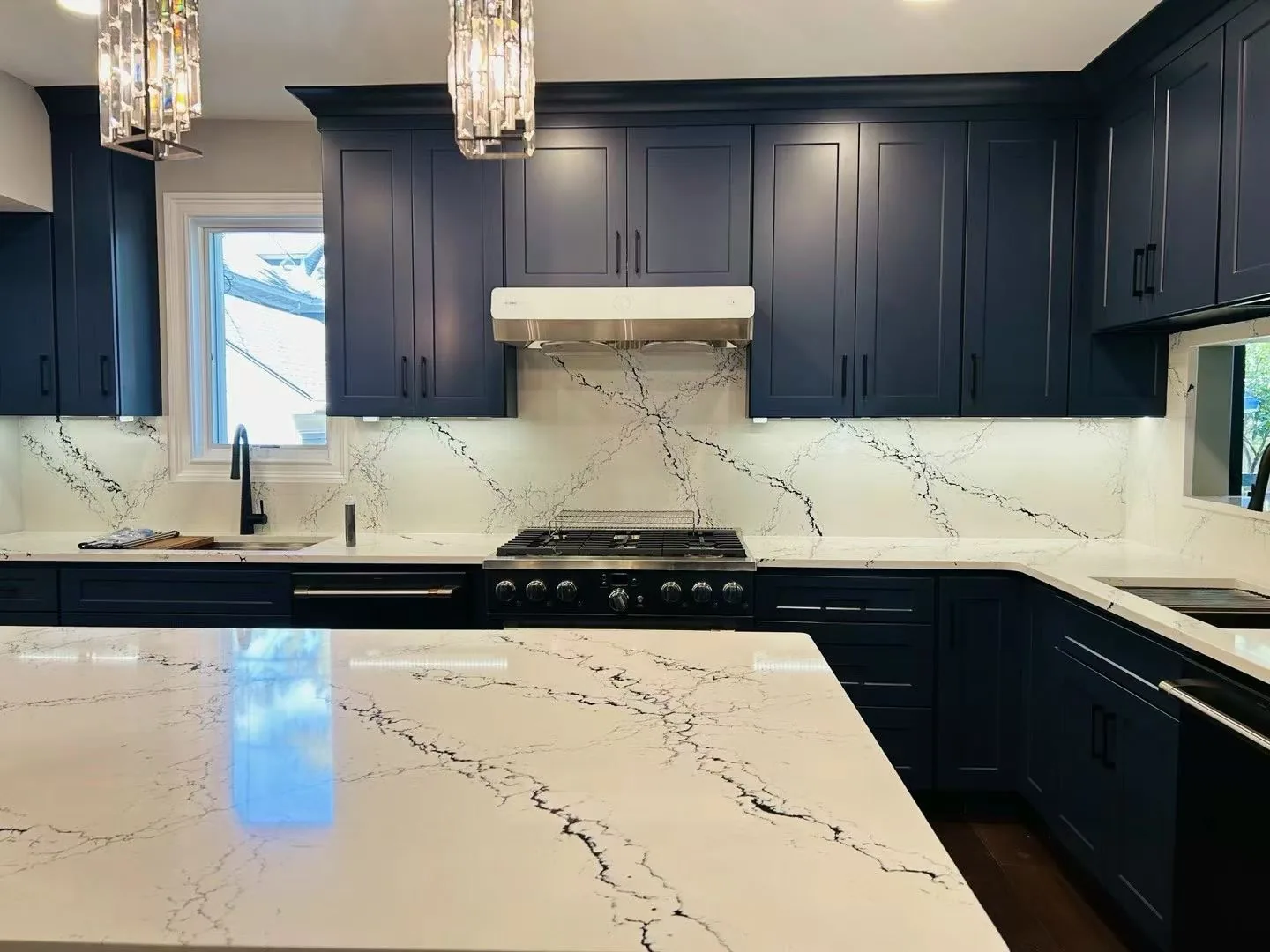 Kitchen remodeling Westchester County NY — navy blue cabinets with full-height quartz backsplash by AlbStar Renovation